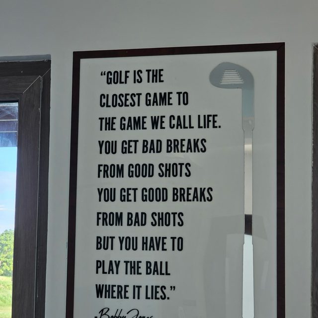 A framed Bobby Jones quote about golf and life on the clubhouse wall