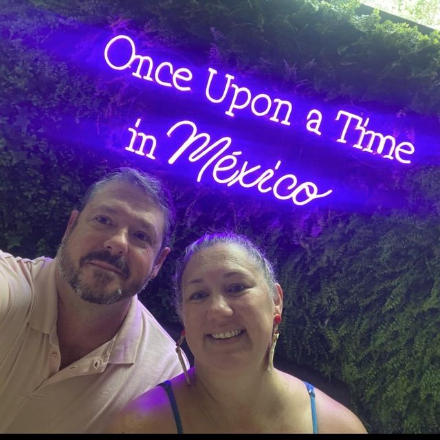 Gunny and Nikki under a neon sign reading Once Upon a Time in Mexico