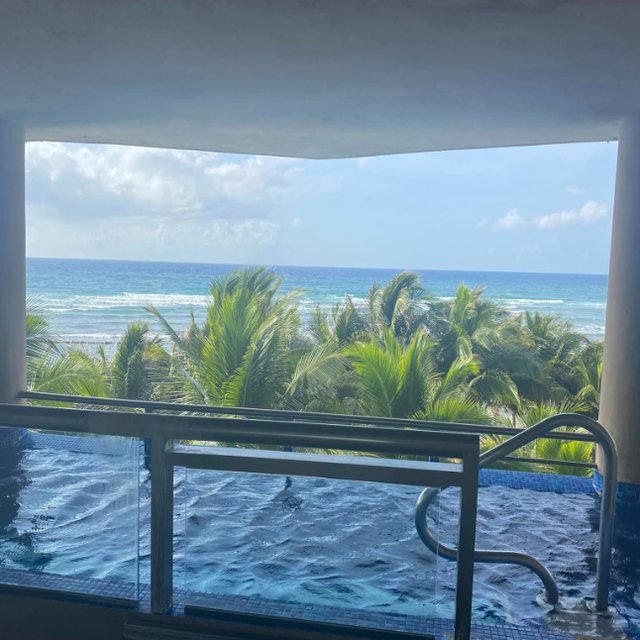 The Caribbean framed by the edge of a balcony pool