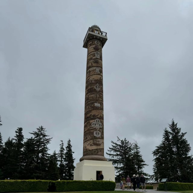 The Astoria Column on its hilltop under a gray sky